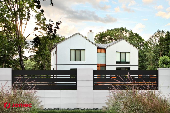 private house with a garden in a rural area under beautiful sky