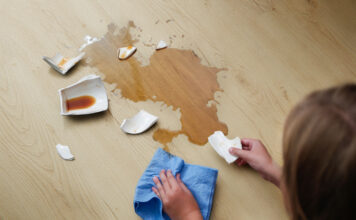 Wodoodporna podłoga do kuchni i łazienki – panele winylowe VIN IN A broken cup of coffee fell on laminate, coffee spilled on floor.